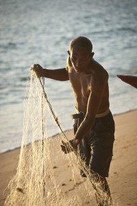 Man with fishing net in Com