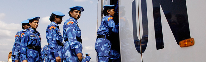 Female Peacekeeper with UN Trucks